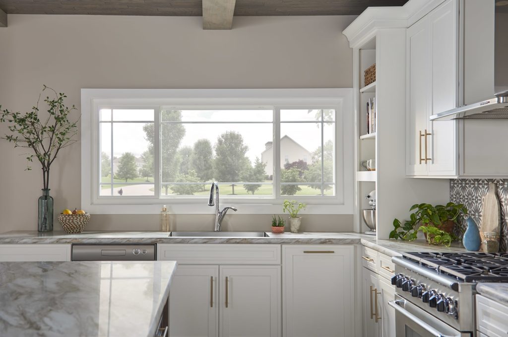 White kitchen with bay window overlooking front yard