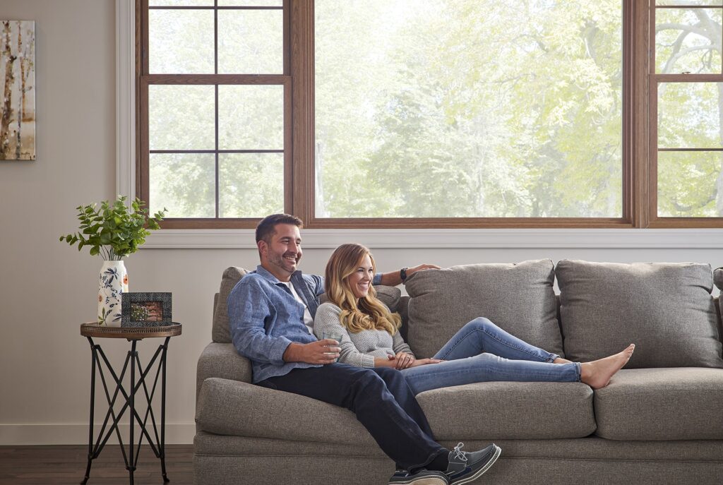 Couple sitting on couch together laughing