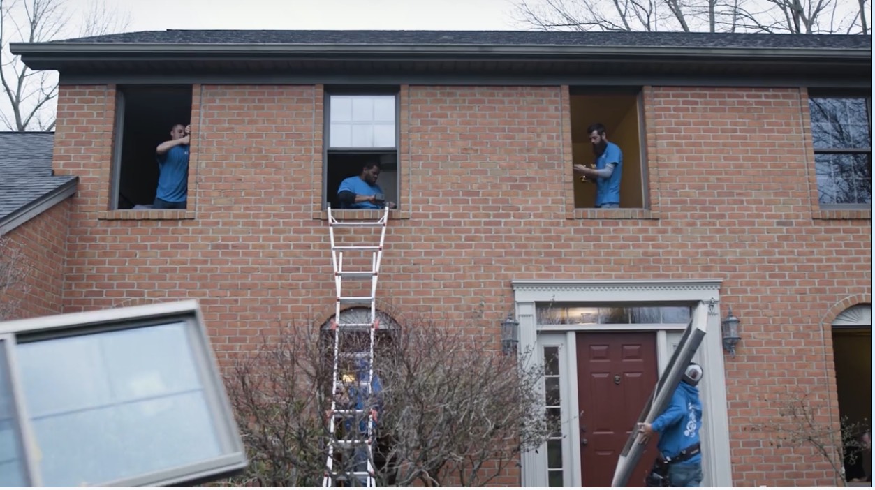 workers replacing window and door screens